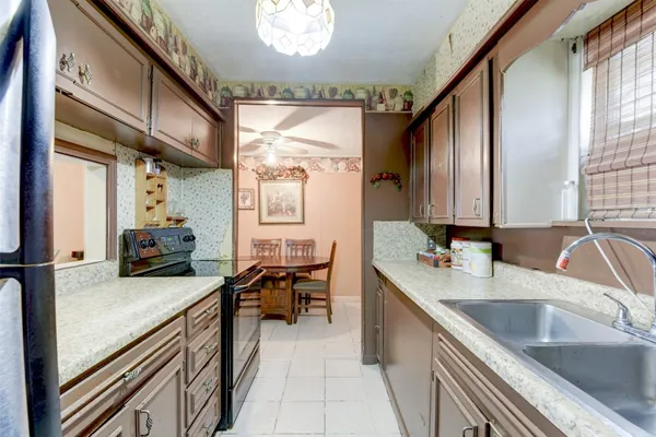 a kitchen with a sink stove and cabinets