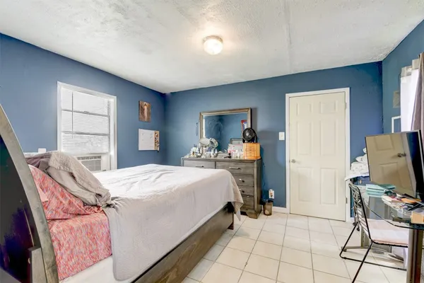 a bedroom with a bed and large mirror in it