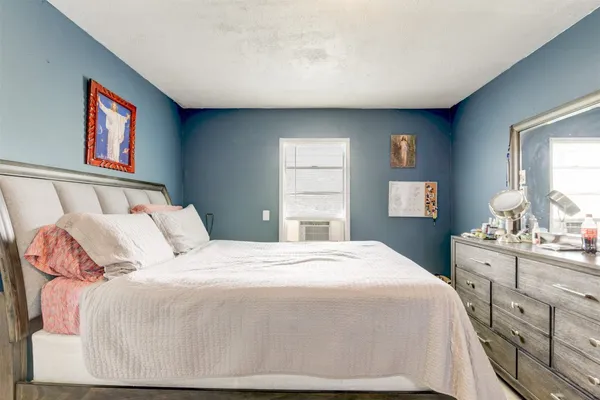 a bedroom with a bed and window