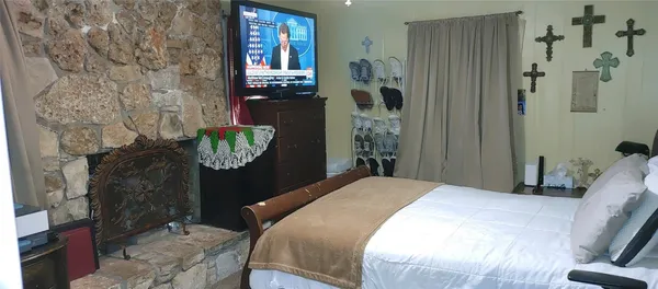 a bedroom with a bed table and chair