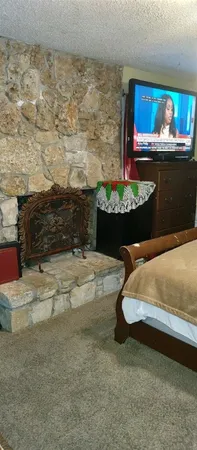 a bedroom with a bed and a fireplace