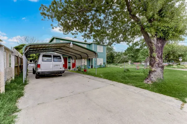 a car parked in front of house with a yard