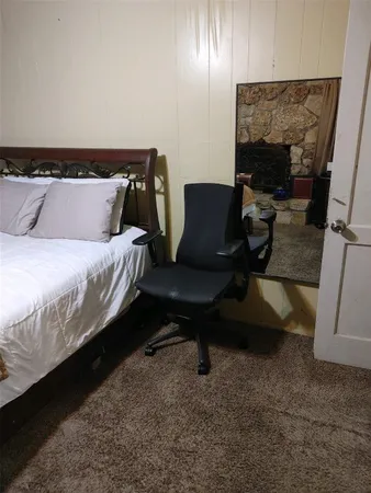 a bedroom with a bed and chair
