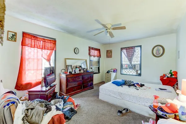 a bedroom with furniture and a window