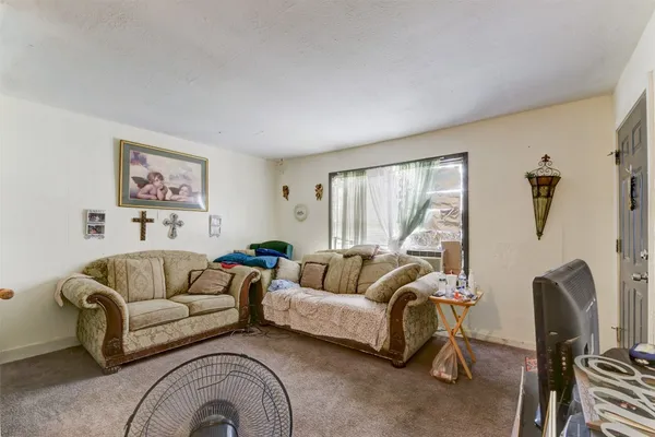 a living room with furniture and a large window