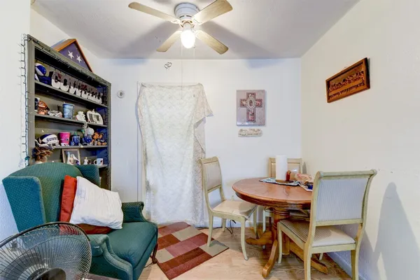 a living room with furniture a rug and a bookshelf
