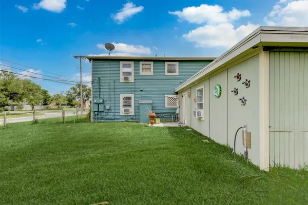 a backyard of a house with table and chairs