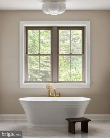 a bathroom has a glass shower door