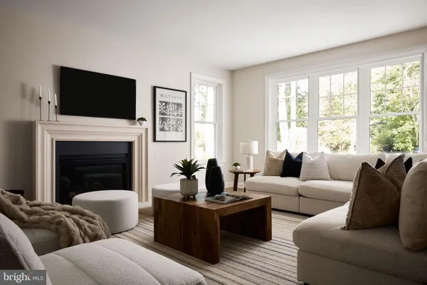a living room with furniture fireplace and flat screen tv