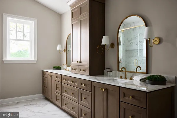 a bathroom with a double vanity sink and a mirror