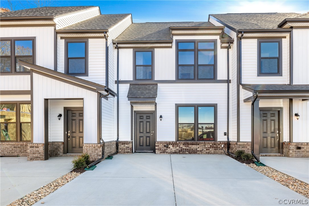 12220 Lightning Bug Loop Midlothian, VA 23112 - Photo 1 of 34 front view of a brick house with a large windows