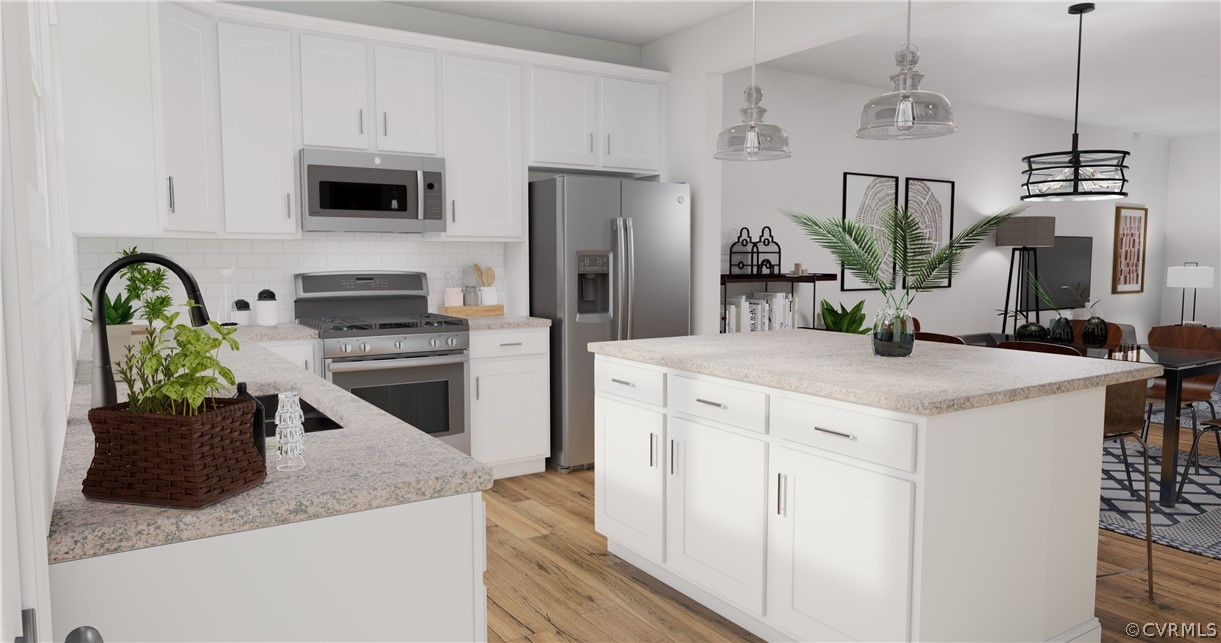 12220 Lightning Bug Loop Midlothian, VA 23112 - Photo 9 of 34 a kitchen with stainless steel appliances granite countertop a sink a microwave a refrigerator and a stove