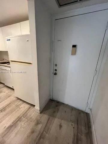a view of a kitchen with a refrigerator