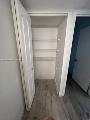 a view of a room with wooden floor