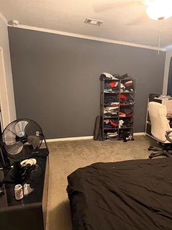 a bedroom with a bed and a wooden floor