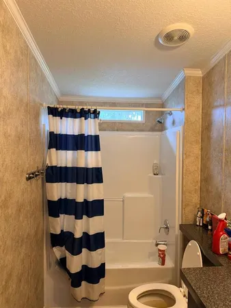 a bathroom with a sink toilet and shower