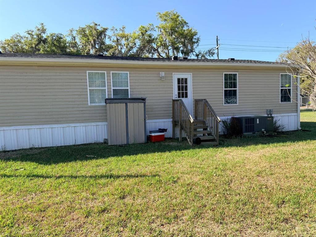 3520 East Gaskins Road, Unit LOT 5 Bartow, FL 33830 - Photo 2 of 16 a view of a backyard with potted plants