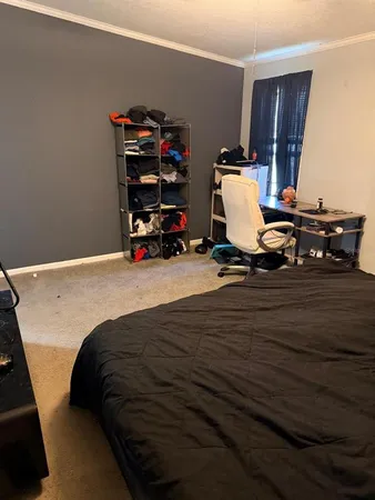 a bed sitting in a room next to a window