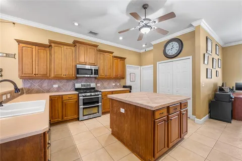 a kitchen with a stove top oven cabinets and a refrigerator