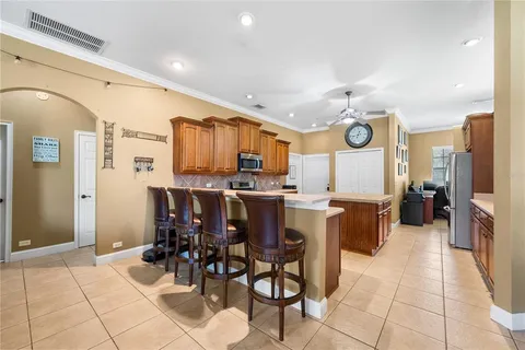 a large kitchen with a table and chairs