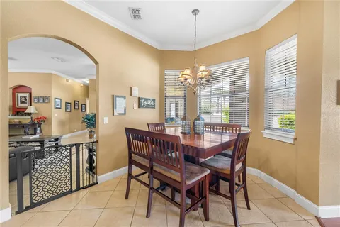 a view of a dining room with furniture and chandelier