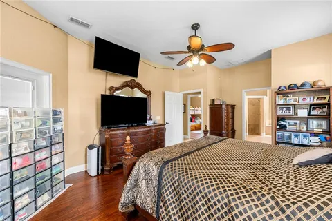 a bedroom with a bed and flat screen tv