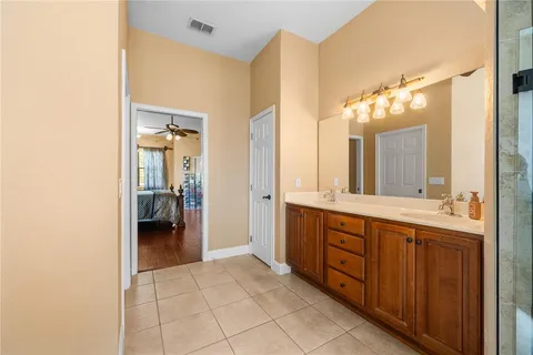 a spacious bathroom with a double vanity sink and a mirror