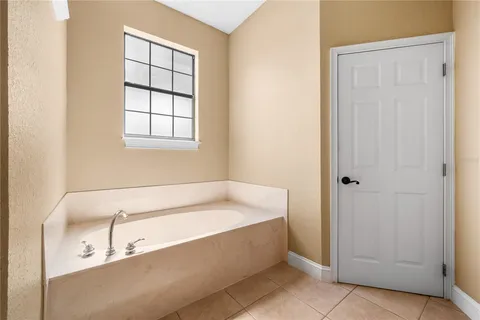 a bathroom with a tub and a window