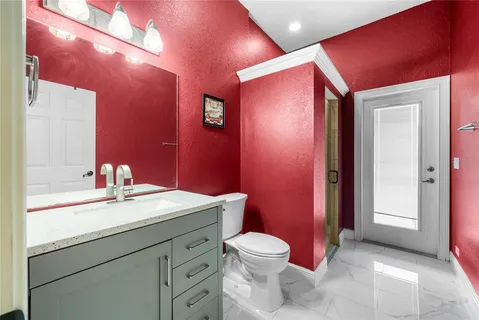 a bathroom with a sink mirror vanity and toilet
