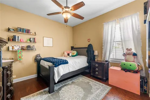a bedroom with a bed dresser and a window