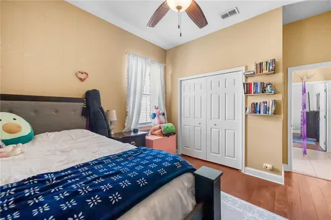 a bedroom with a bed a dresser and book shelf