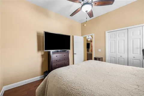 a bedroom with a bed and a flat screen tv