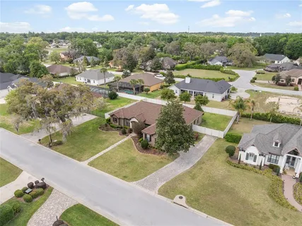 an aerial view of residential houses with outdoor space and parking