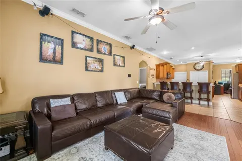 a living room with furniture and a chandelier