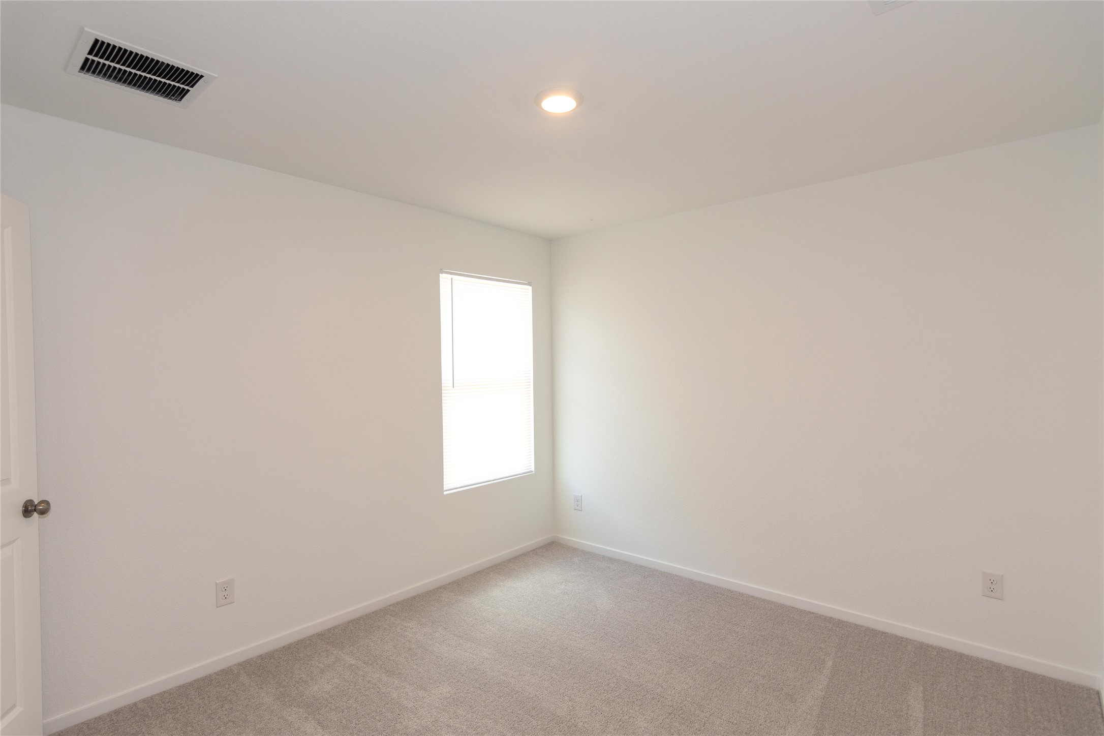 149 Star Packer Lane Jarrell, TX 76537 - Photo 17 of 30 A well-lit, neutral-toned room features soft carpeting and a single window, ready for personalization.