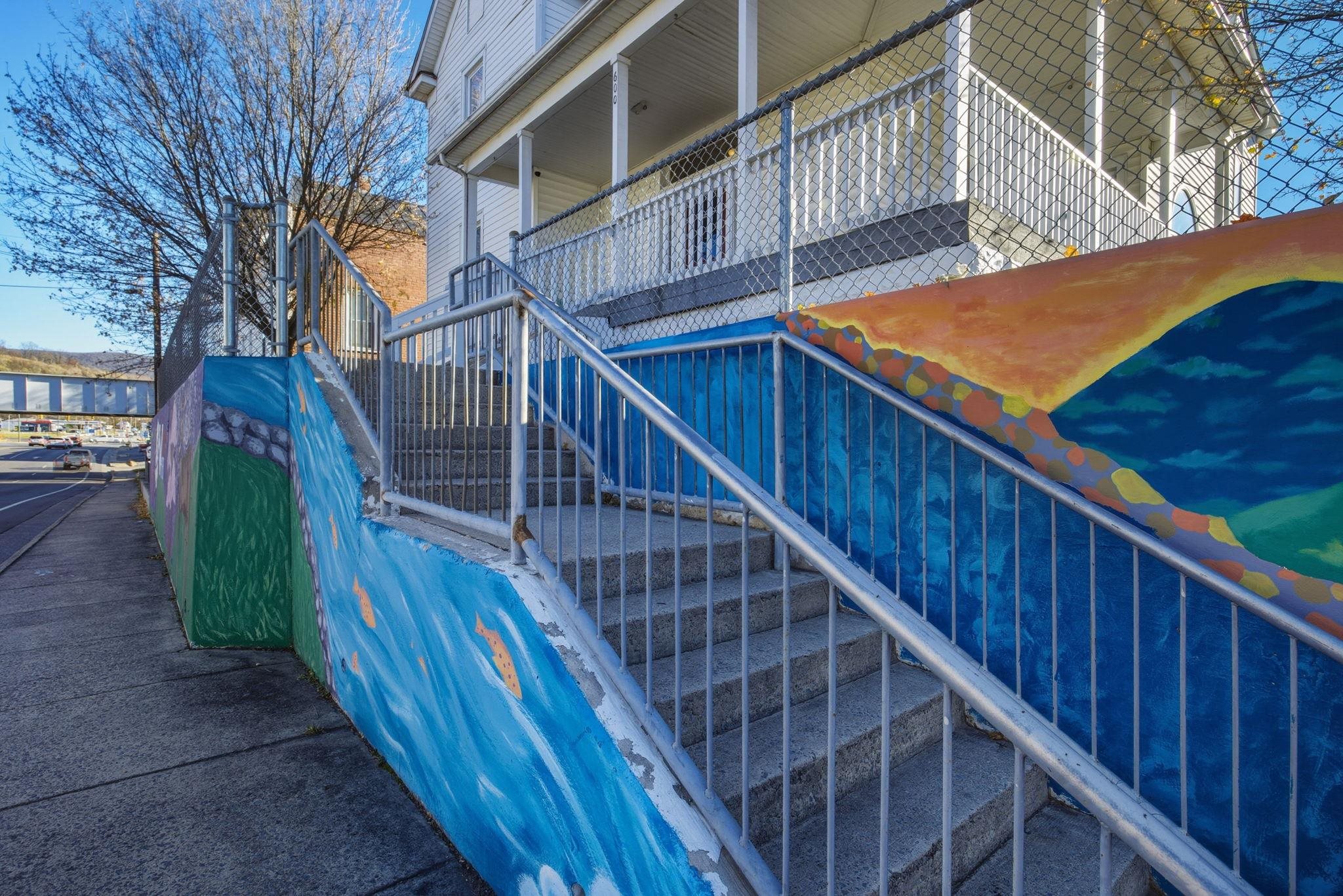 a view of balcony with wooden floor and stairs