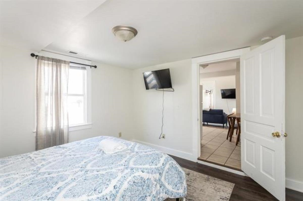 600 East Main Street Waynesboro, VA 22980 - Photo 19 of 33 a bedroom with a bed and a flat screen tv