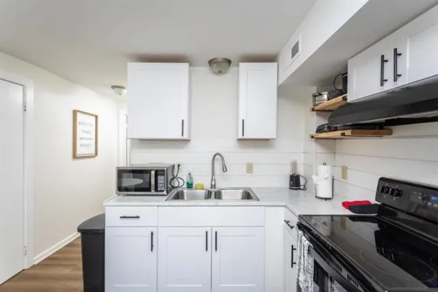 a view of a bedroom with wooden floor