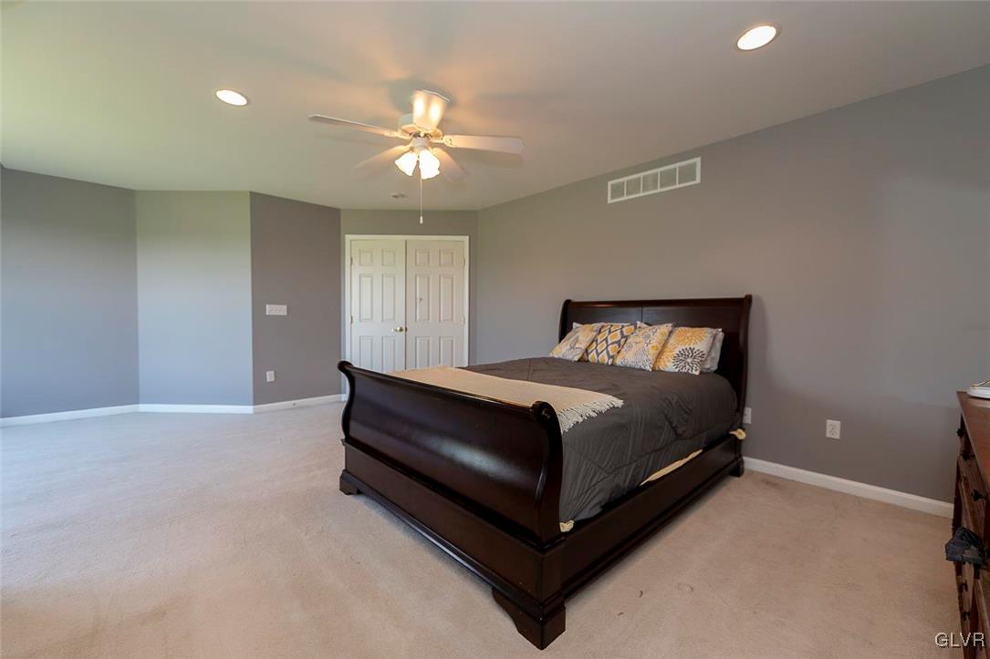 778 Bushkill Center Road Nazareth, PA 18064 - Photo 18 of 27 a bedroom with a bed and a chandelier