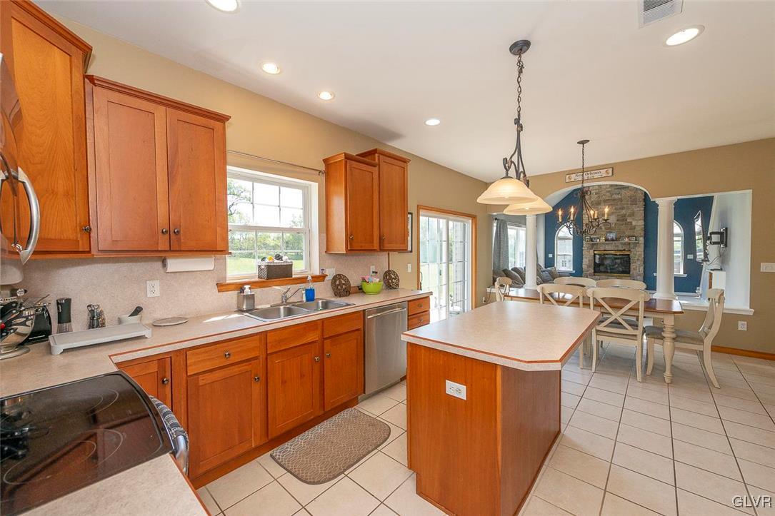 778 Bushkill Center Road Nazareth, PA 18064 - Photo 8 of 27 a large kitchen with kitchen island a sink a counter top space and stainless steel appliances