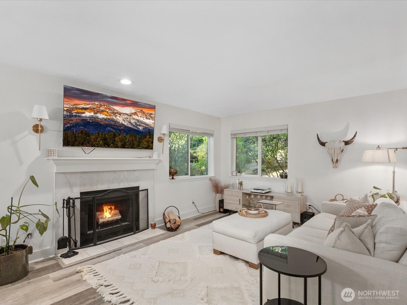 455 Newport Way Northwest, Unit 302 Issaquah, WA 98027 - Photo 1 of 1 a living room with furniture a fireplace and a flat screen tv