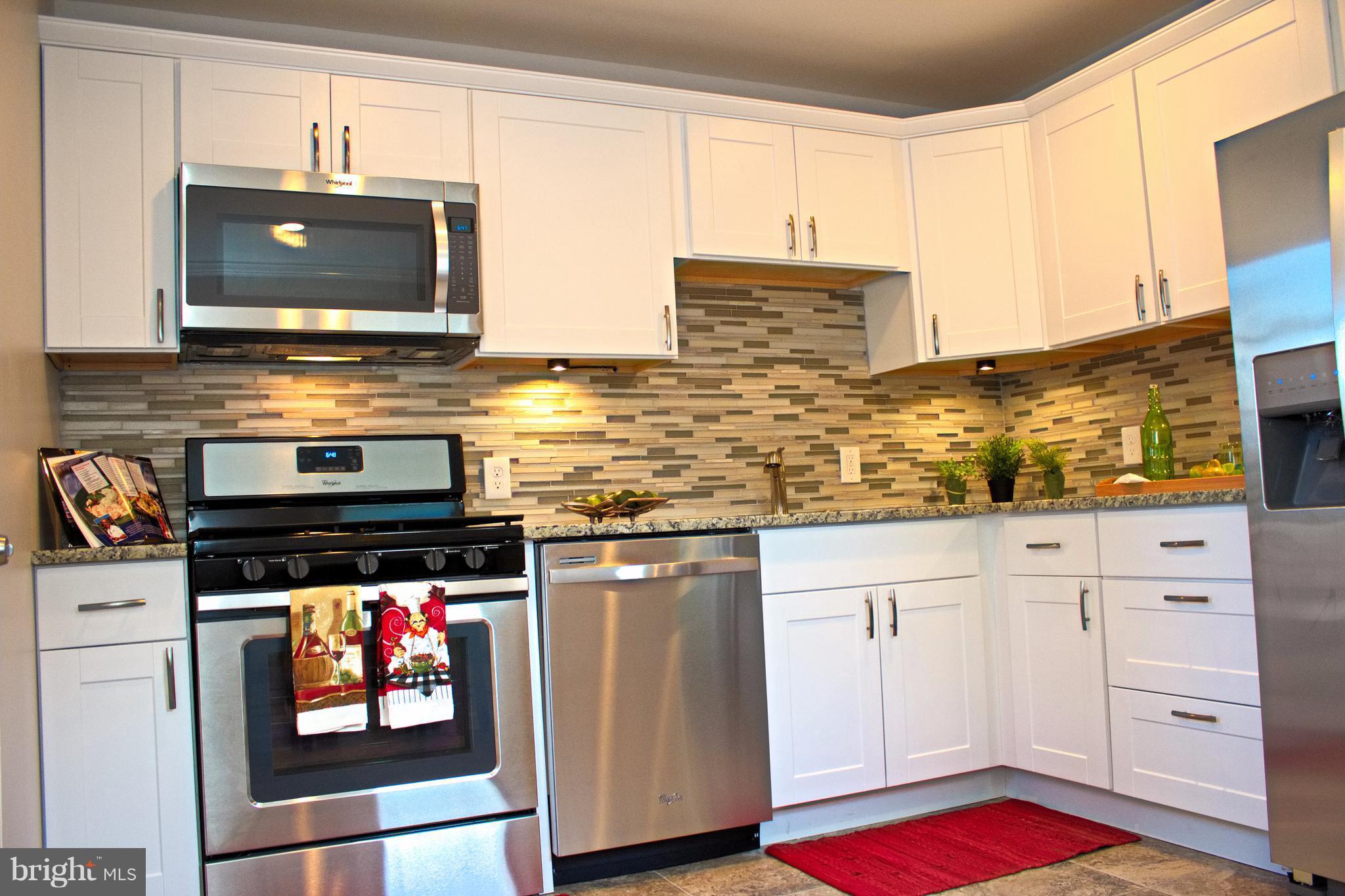 315 Highfalcon Road Reisterstown, MD 21136 - Photo 11 of 30 a kitchen with stainless steel appliances granite countertop a stove and a microwave