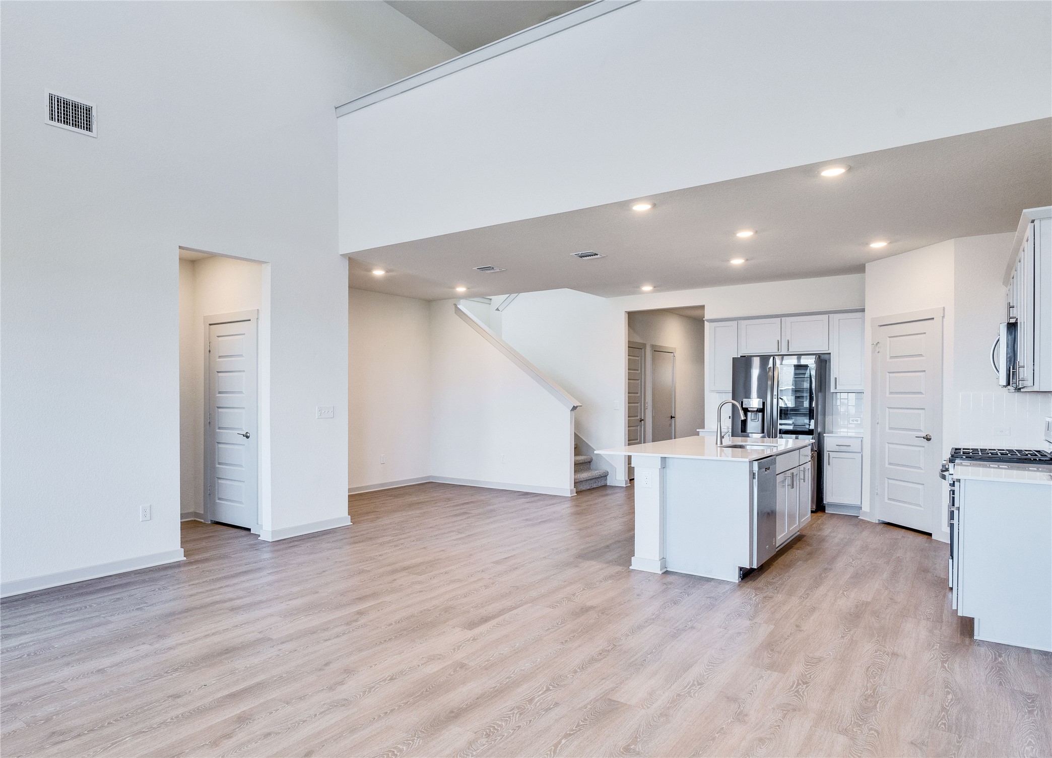 10508 Defender Trail Austin, TX 78754 - Photo 11 of 28 An open-concept living space integrates a well-appointed kitchen with a bright, airy living area and a sleek staircase.