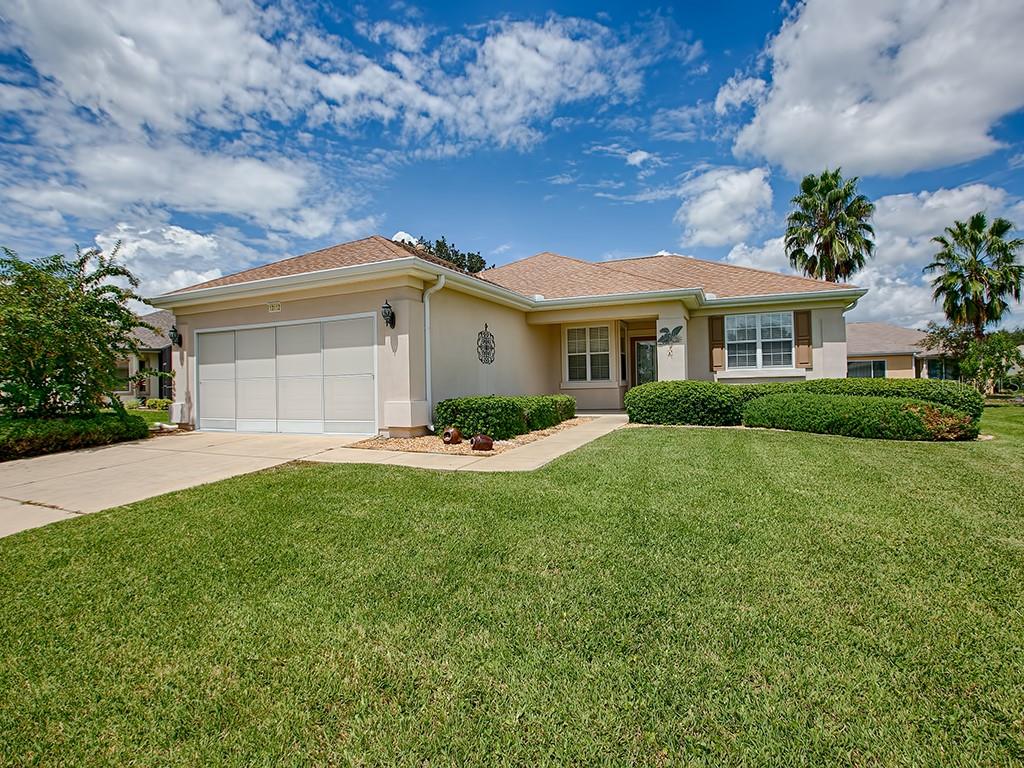 13112 Southeast 93rd Terrace Road Summerfield, FL 34491 - Photo 1 of 1 a front view of a house with a yard and garage