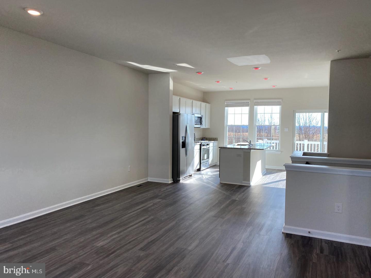 1992 Fauna Drive Frederick, MD 21702 - Photo 11 of 24 a view of a kitchen with a fridge and wooden floor
