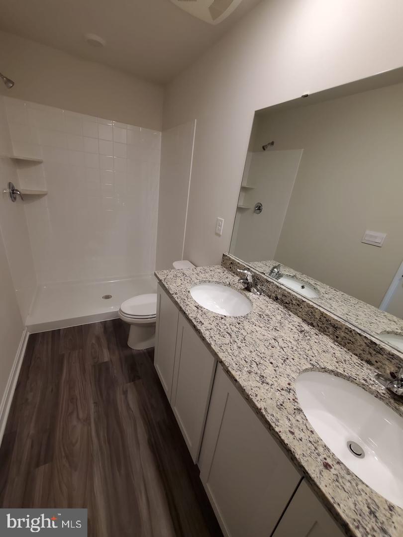 1992 Fauna Drive Frederick, MD 21702 - Photo 21 of 24 a bathroom with a granite countertop sink a toilet and a large mirror