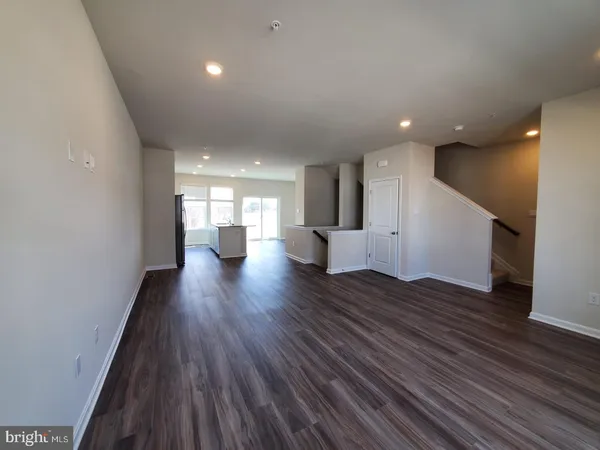 a view of an empty room and wooden floor