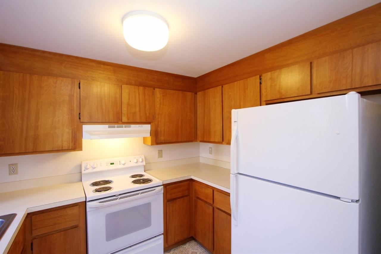 89 Depot Road Chatham, MA 02633 - Photo 8 of 17 a kitchen with a refrigerator and a stove top oven
