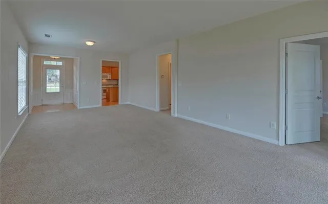 a view of a backyard and floor to ceiling window