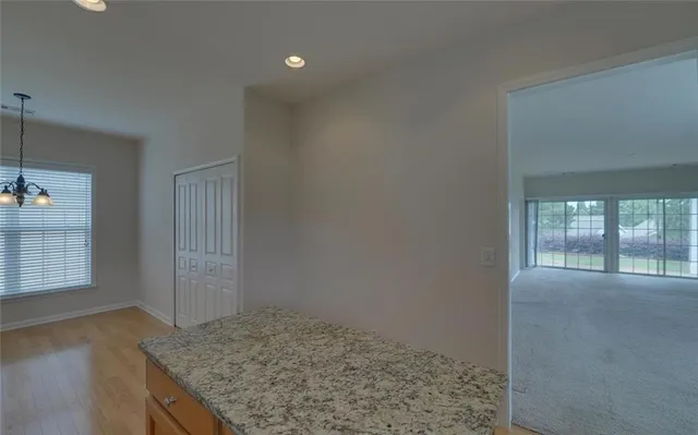 a kitchen with stainless steel appliances granite countertop a sink refrigerator and cabinets